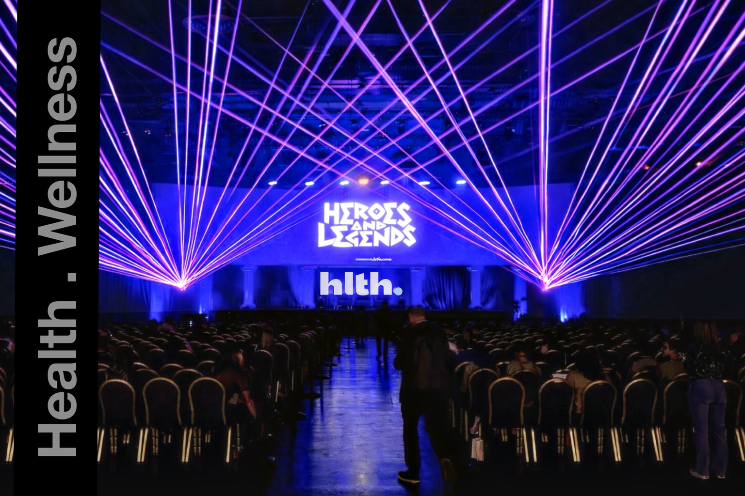 Purple and blue laser beams framing the HLTH Heroes and Legends stage