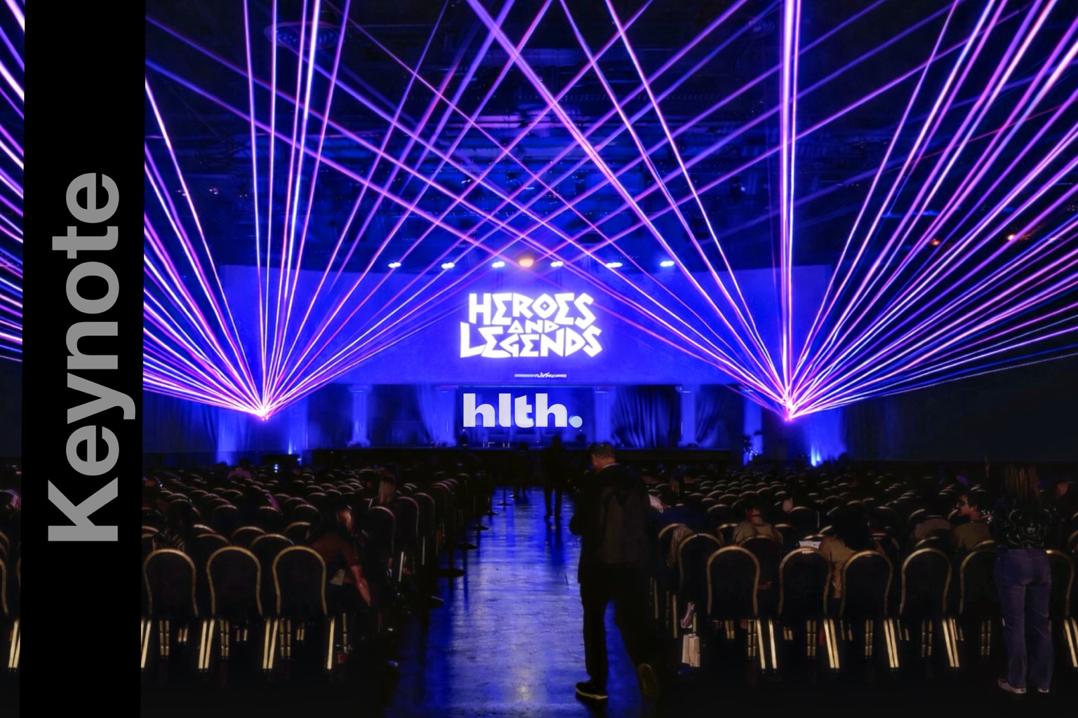 Purple and blue laser beams framing the HLTH Heroes and Legends stage
