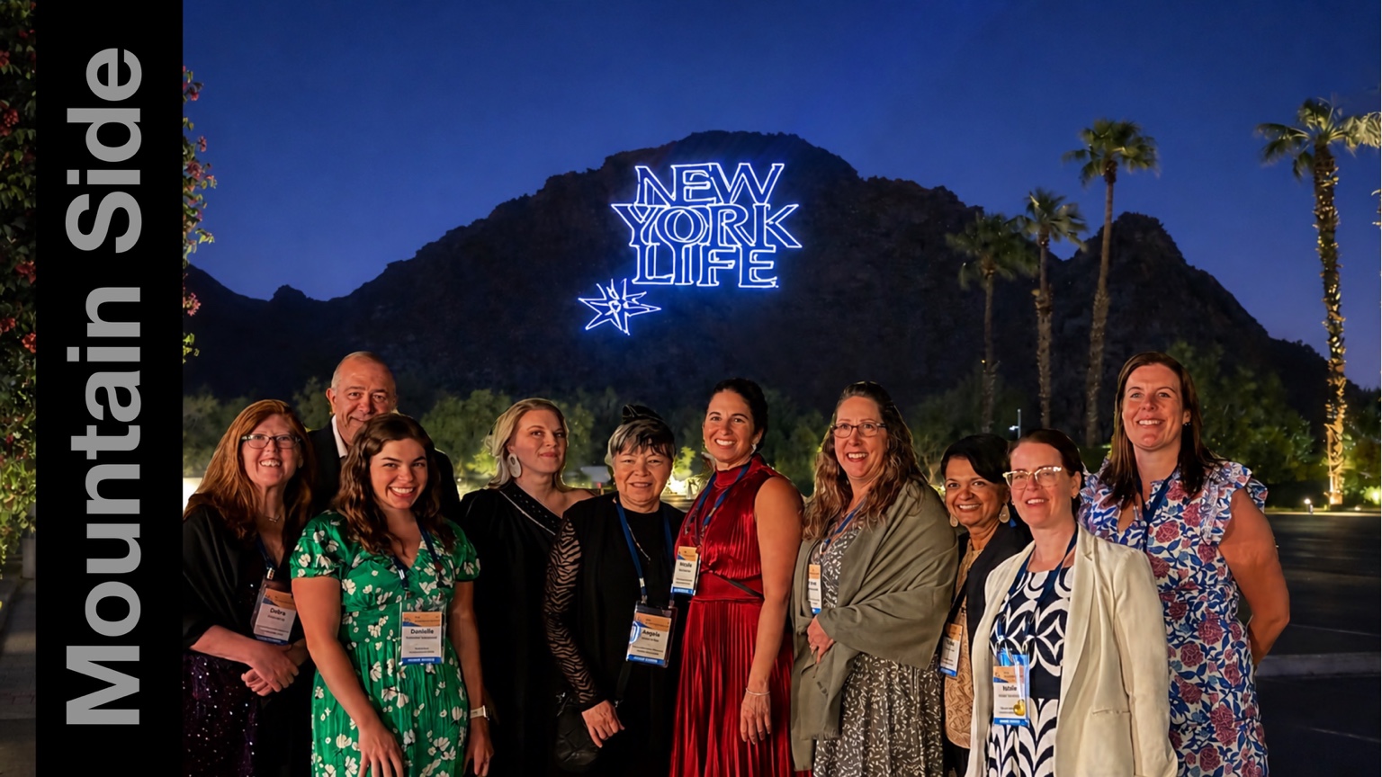 New York Life logo displayed on a mountainside behind event guests
